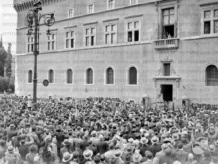 La folla festante accoglie Mussolini che affacciato al balcone di ...