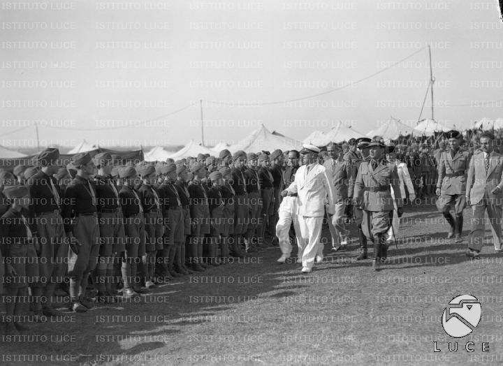 Accompagnato da personalità e un capo centuria, Mussolini passa in ...