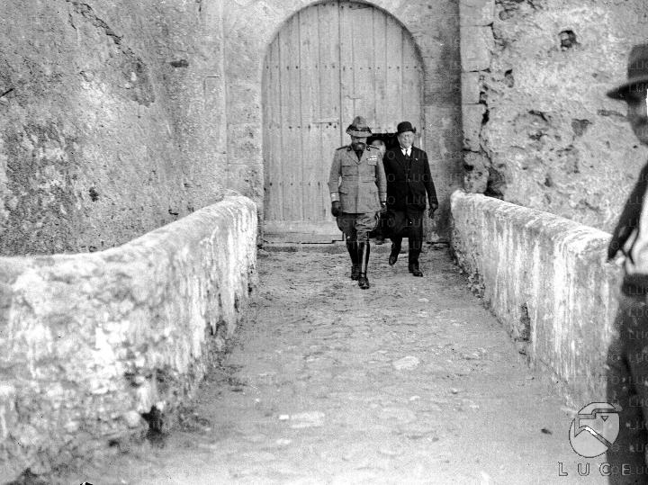 Pizzo Calabro Teruzzi, accompanied by a personality in civilian clothes, moves away from the entrance portal of the Aragonese castle of Pizzo Calabro