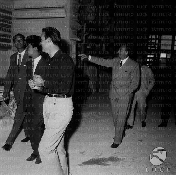 Rome Carmine Gallone visits a Cinecittà warehouse with Akira Kurosawa and others.