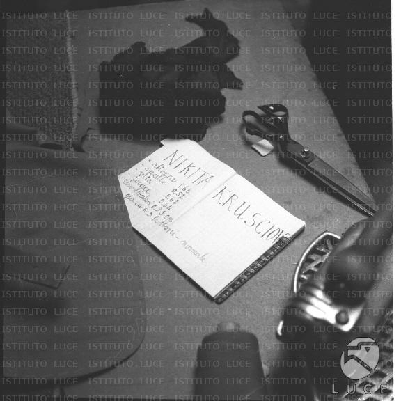 Column open on a tailor's table on which the measurements of\ "Nikita Khrushchev\" are marked.. total