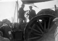 Mussolini in piedi su un trattore con un lavorator ...