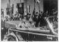 Mussolini, a bordo di un'auto scoperta,  ...
