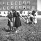 Ragazze trasportano le patate con cestini; sullo s ...