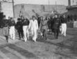 Mussolini, accompagnato da un gruppo di autorit�,  ...