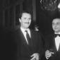 Pietro Germi sorridente in compagnia di una person ...