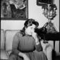 Anna Magnani seduta su un divano in casa sua duran ...